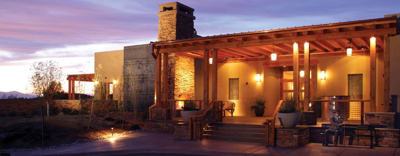 Encantado Resort at dusk — a stone-and-timber portal glowing under a violet New Mexico sky.